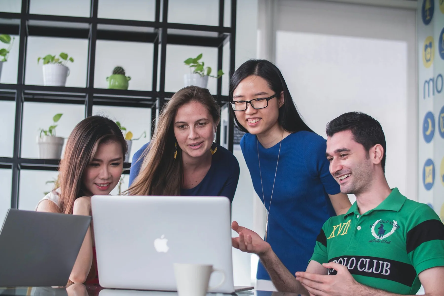 A team working together around a laptop